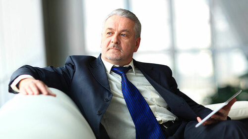 Portrait of a mature businessman with digital tablet