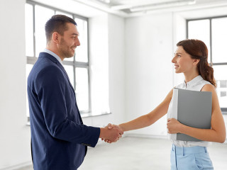 businesswoman and businessman shake hands