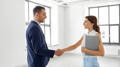 businesswoman and businessman shake hands