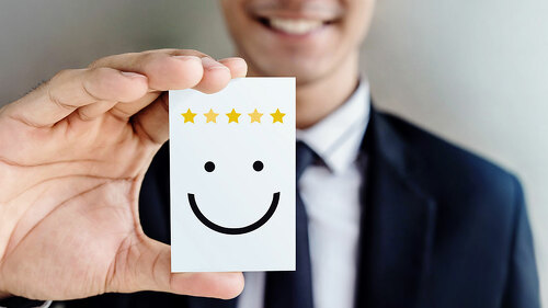 Customer Experience Concept, Happy Businessman holding Card with