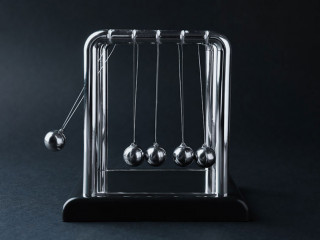 Newton's cradle on dark background. Physics law of energy conser