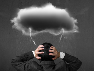 Depressed man with dark cloud rain lightning over his head