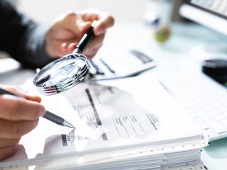 Audit And Fraud Investigation. Auditor Using Magnifying Glass