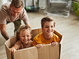 Father Playing with Sons in New House