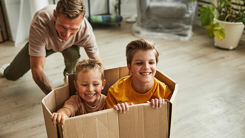Father Playing with Sons in New House