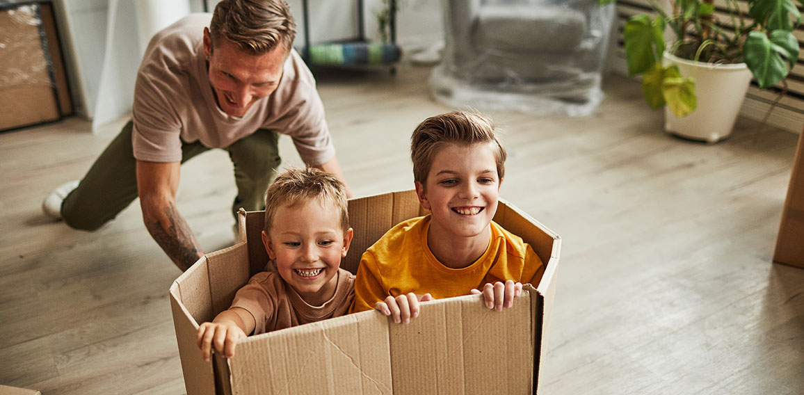 Father Playing with Sons in New House