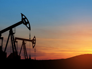 Oil drilling derricks at desert oilfield. The change in oil prices caused by the war. Oil prices are rising.