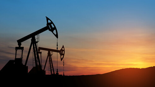 Oil drilling derricks at desert oilfield. The change in oil prices caused by the war. Oil prices are rising.