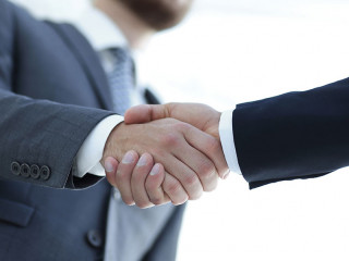 Successful business people handshaking after good deal.
