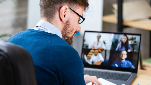 Successful confident top manager or coach, holding video confere