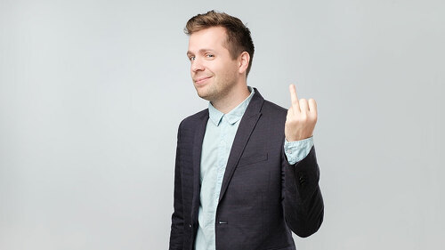 Caucasian man in suit showing his finger without marriage ring. He has divorced and now is very happy to be free