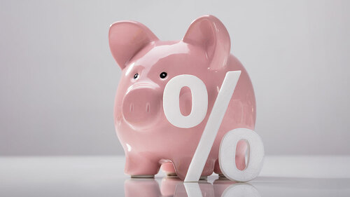 Close-up Of Percentage Sign And Piggy Bank