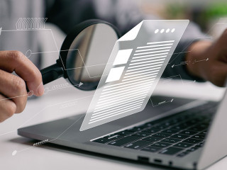 Man inspecting paperwork with magnifier. A business analysis con