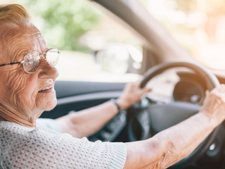 Elderly woman behind the steering wheel