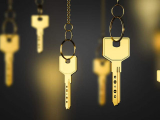 Gold keys on chains, real estate concept