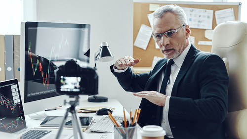 Senior man in elegant business suit using modern technologies wh