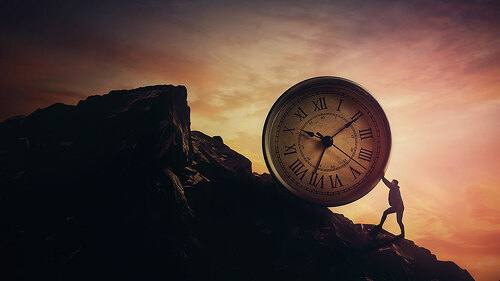 Surreal scene with a businessman pushing a clock up a hill. Time