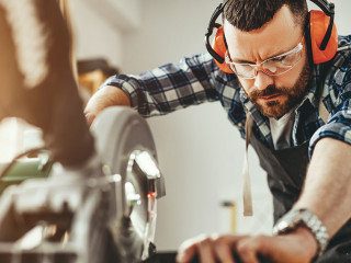 young male carpenter working in workshop