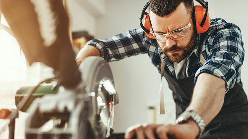 young male carpenter working in workshop