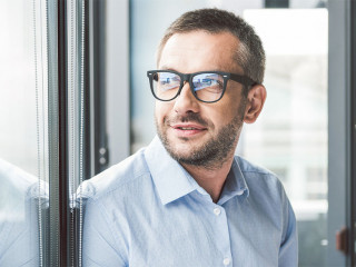 Joyous smiling man keeping papers