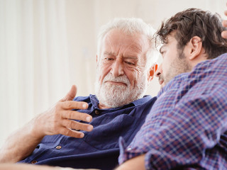 old man serious discussion with younger man indoor, grand father