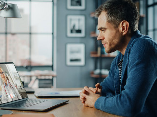 Handsome Caucasian Man Having a Video Call with Female Doctor on