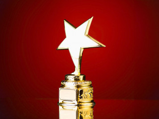 gold star trophy against blue background