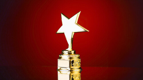 gold star trophy against blue background