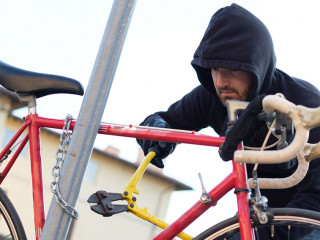 Thief stealing a bike in the city street