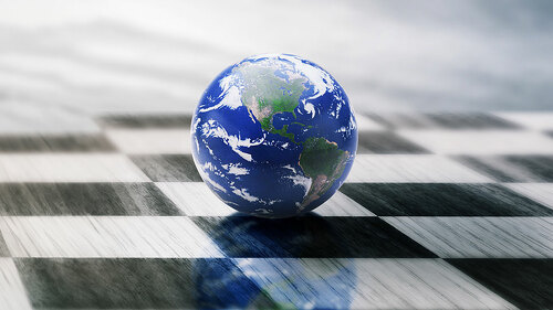 world on a chessboard isolated on blue sky background