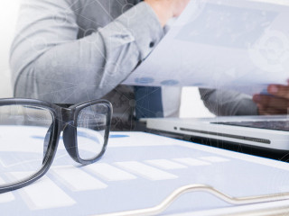 business documents on office table with smart phone and laptop c