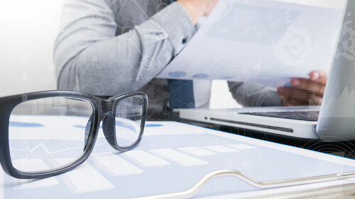 business documents on office table with smart phone and laptop c