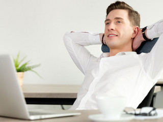 Smiling businessman relaxing in the office