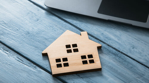wooden house model with computer