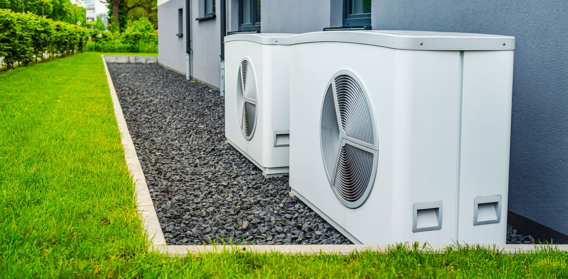 Two air source heat pumps installed outside of new and modern ci