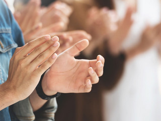 Cropped image of Creative designers audience applauding at a bus