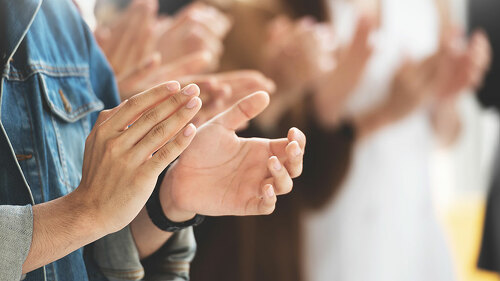 Cropped image of Creative designers audience applauding at a bus