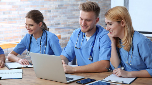 Medical students in uniforms studying at university