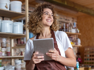 Craftswoman with tablet computer in art studio