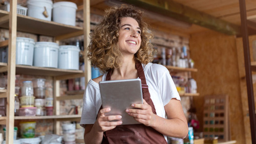 Craftswoman with tablet computer in art studio