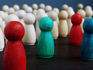 Diversity and inclusion concept. Crowd of wooden figures and color figures.