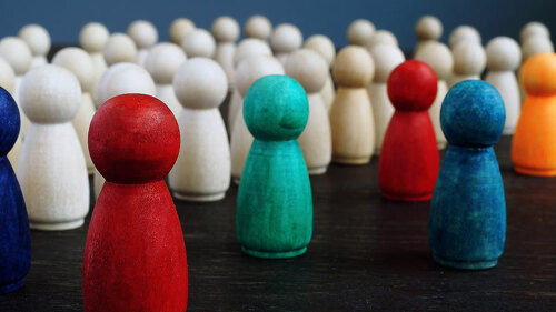 Diversity and inclusion concept. Crowd of wooden figures and color figures.
