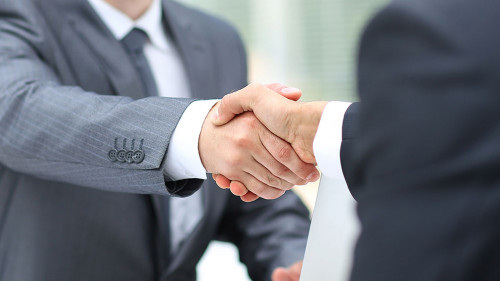 Business man shaking hand to partner