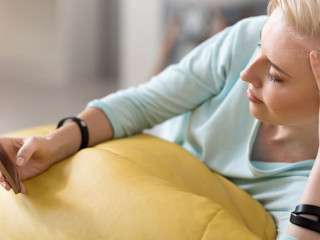 Relaxed woman using smart phone