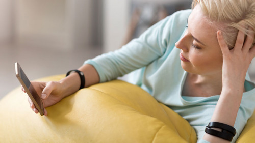 Relaxed woman using smart phone