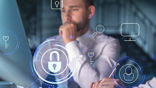 Two colleagues working together to protect clients confidential information and cyber security. IT hologram padlock icons modern office background at night time