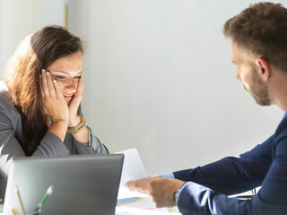 Businessman Showing Document To Female Employee