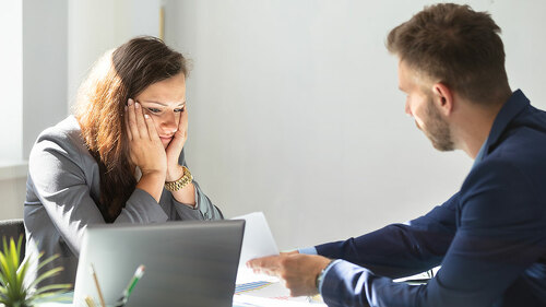 Businessman Showing Document To Female Employee