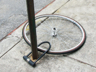 Bike wheel with padlock. Theft of a bicycle. Bicycle stolen and left only wheel.