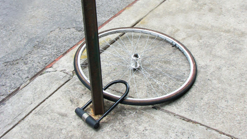 Bike wheel with padlock. Theft of a bicycle. Bicycle stolen and left only wheel.
